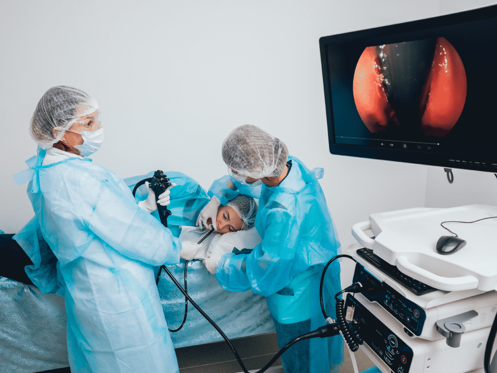 Doctor performing gastroscopy on patient